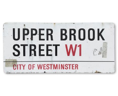 An enamelled iron street sign for Upper Brook Street W1, City of Westminster, with iconic and black and red sans serif letter