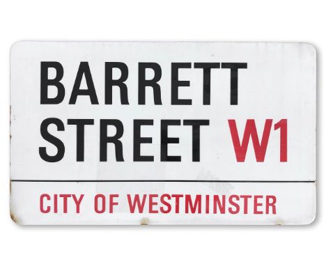 An enamelled iron street sign for Barrett Street W1, City of Westminster, with iconic and black and red sans serif lettering 