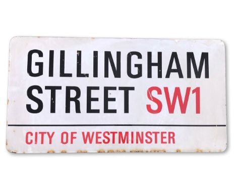An enamelled iron street sign for Gillingham Street SW1, City of Westminster, on wooden frame to back, with iconic and black 