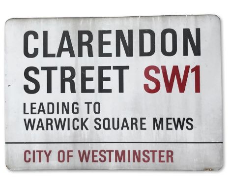 An enamelled iron street sign for Clarendon Street SW1 leading to Warwick Square Mews, City of Westminster with iconic black 