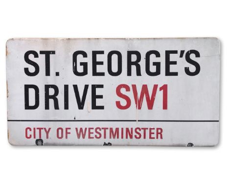 An enamelled iron street sign for St George's Drive, City of Westminster, with iconic and black and red sans serif lettering 