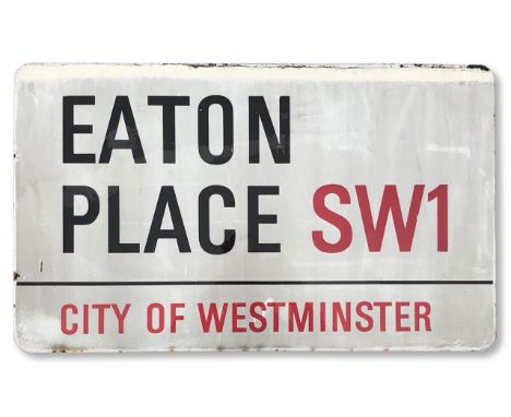An enamelled iron street sign for Eaton Place SW1, City of Westminster, with iconic and black and red sans serif lettering fi