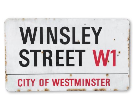 An enamelled iron street sign for Winsley Street W1, City of Westminster, with iconic and black and red sans serif lettering 