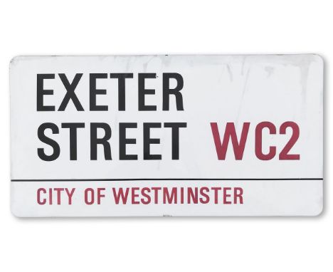 An enamelled iron street sign for Exeter Street WC2, City of Westminster, with iconic and black and red sans serif lettering 