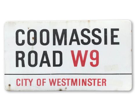 An enamelled iron street sign for Coomassie Road W9, City of Westminster, with iconic and black and red sans serif lettering 