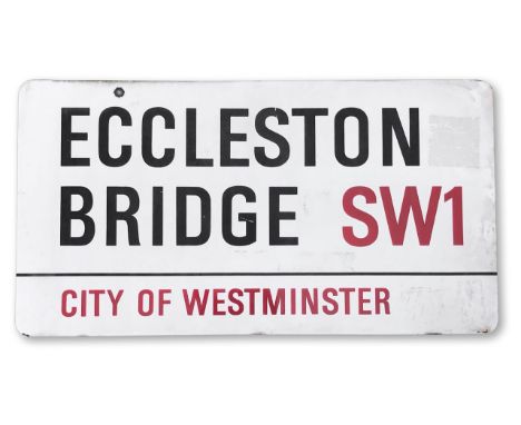 An enamelled iron street sign for Eccleston Bridge SW1, City of Westminster, on wooden frame to back, with iconic black and r