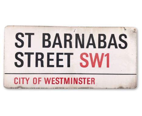 An enamelled iron street sign for St. Barnabas Street SW1, City of Westminster, with iconic black and red sans serif letterin