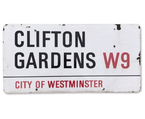 An enamelled iron street sign for Clifton Gardens W9, City of Westminster with iconic black and red sans serif lettering firs