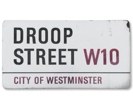 An enamelled iron street sign for Droop Street W10, City of Westminster, with iconic and black and red sans serif lettering f