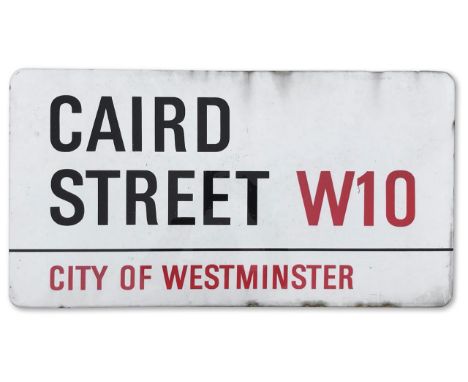 An enamelled iron street sign for Caird Street W10, City of Westminster with iconic black and red sans serif lettering first 