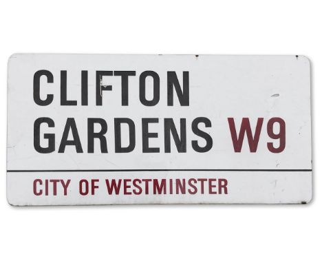 An enamelled iron street sign for Clifton Gardens W9, City of Westminster with iconic black and red sans serif lettering firs