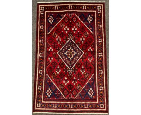 A North West Persian Josheghan rug / carpet, hand-knotted with central diamond medallion within a field of stylised motifs, i