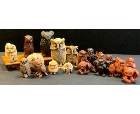 A modern carved wooden netsuke, as a standing Owl;  others, perched, stylised, black forest style owl inkwell;  deck blotter 