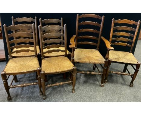 A matched set of six ladder back dining chairs, woven rush seats - comprising a 19th century elm carver chair, matching dinin