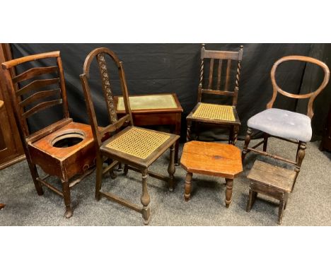 A Victorian rosewood hoop back hall chair, turned legs and stretchers, c.1860;  an Edwardian hall chair, Bergere weave seat, 