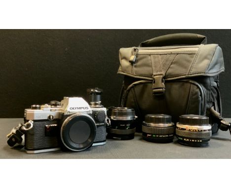 An Olympus OM10 SLR 35mm camera body, 28mm, 50mm and x2 multiplier lenses, motor wind etc 