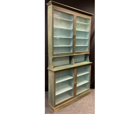 A late Victorian painted mahogany shop display / bookcase cabinet, architectural pediment, glazed doors to top and base, four