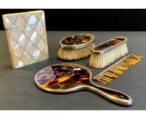 George V silver mounted faux tortoiseshell three piece dressing table set, London 1927; comprised of mirror, comb and brushes