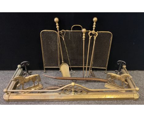 A brass fender, three piece ball top companion set;  folding fire screen, pair of brass horse front fire dogs;  pair of Horse