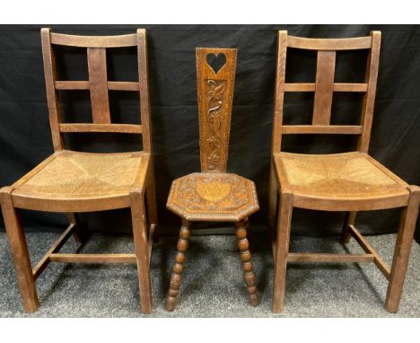 An Arts and crafts oak spinning chair, carved back and seat, bobbin turned legs, 84.5cm high, c.1900;  a pair of early 20th c