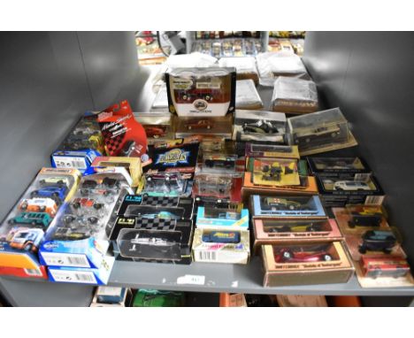 A shelf of mixed vintage die-casts including 1973 Matchbox Models of Yesteryea0, 1980's Matchbox, 2002 Mattel Hotwheels, Fabb