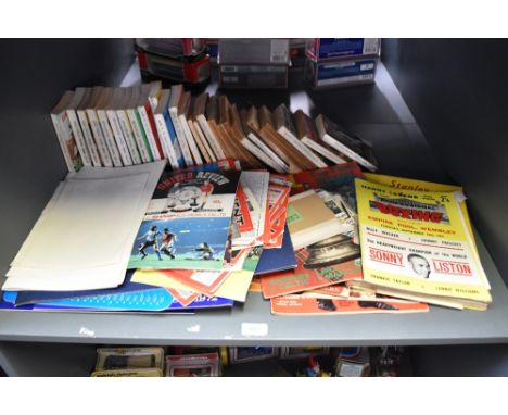 A shelf of Football Programmes, Books and Medallions including Leyton Orient Programmes, 1960's Goal Magazines, News of the W