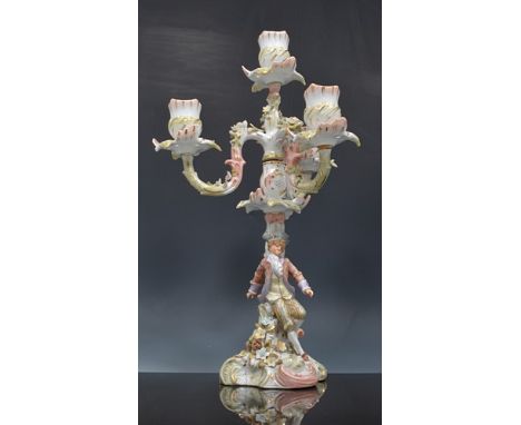 Sitzendorf four light candelabra, encrusted decoration, the column modelled with a standing figure, 35cm and a pair of Capodi