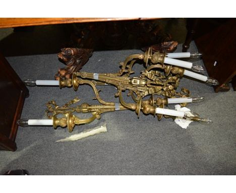 Set of four French Empire style gilt metal two light wall brackets, of quiver form with ribbon ties, 56cm excluding candle fi