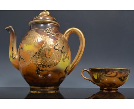 Japanese egg shell type porcelain tea set, decorated with dragons against a marbled ground. 