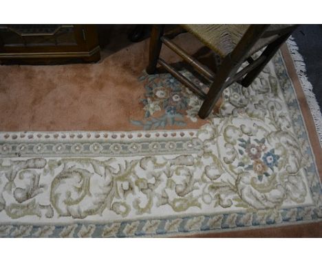 Indian wool carpet, central medallion on a terracotta coloured field, border within guards, 360cm x 280cm.