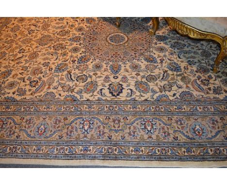 Persian pattern small carpet, fawn ground with a central floral medallion, trellis field within spandrels, broad border, appr