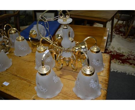 Pair of brass and moulded glass five light chandeliers, with frosted shades, 41cm drop and a two light wall bracket to match 