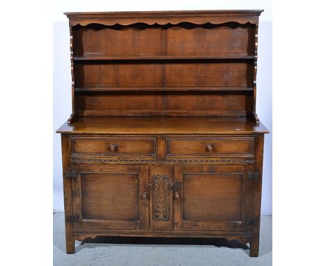 Reproduction oak dresser, two shelf delft rack, base with two drawers over two panelled doors, width 127cm.