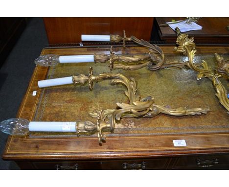 Pair of rococo style gilt metal two light wall sconces, foliate design, 47cm excluding candle fitments and two similar two li