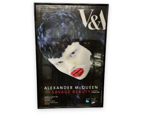 An original Perspex-framed poster from The Victoria & Albert museum sell-out exhibition of the late British fashion designer 