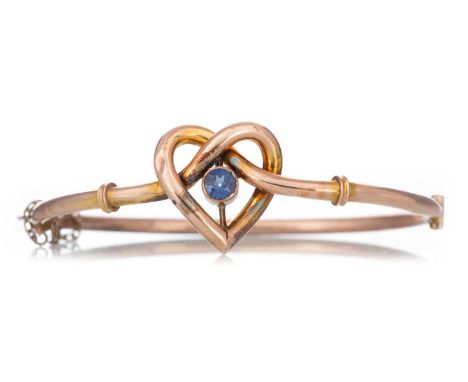 GEM SET BANGLE  the heart shaped centre set with a blue stone, marked 9CT  Qty: 5g  Well worn. Discoloured. Bashed in multipl