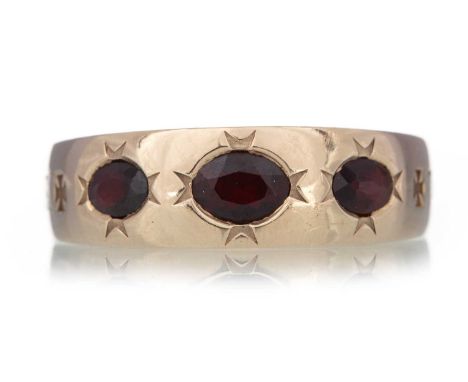 GARNET THREE STONE RING with 'nec tamen consumebatur'  to the shank and sizing bar, in nine carat gold, size Z+Qty: 14.1g