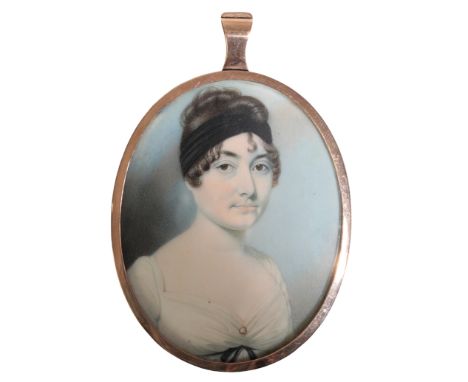 A REGENCY PORTRAIT MINIATURE OF 'CHARLOTTE PAGER' early 19th century, inscribed to the reverse, in an unmarked yellow metal m