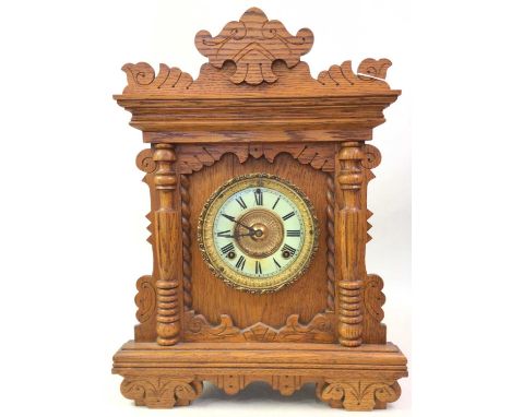 VICTORIAN OAK BRACKET CLOCK, LATE 19TH CENTURY the cream enamel and gilt metal circular dial with numerals in black48cm high