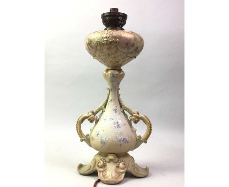 DOULTON BURSLEM OIL LAMP, the ovoid twin-handled body with trumpet neck, decorated with foliage and gilt highlights45cm high 