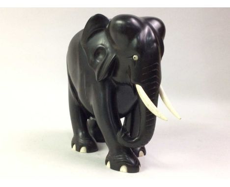 CARVED WOOD FIGURE OF AN ELEPHANT, AND OTHER ITEMS comprising a ceramic figure of a woman and two further carved wood figures