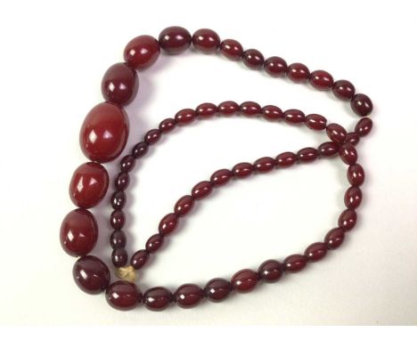 TWO CHERRY BAKELITE NECKLACES, along with a collection of loose beadsQty: approx 130g grossImages of beads over light have be