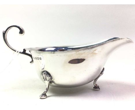 SILVER SAUCE BOAT, BIRMINGHAM MARKS along with a silver sauce ladle and sugar sifter, the ladle Sheffield marks and the sifte