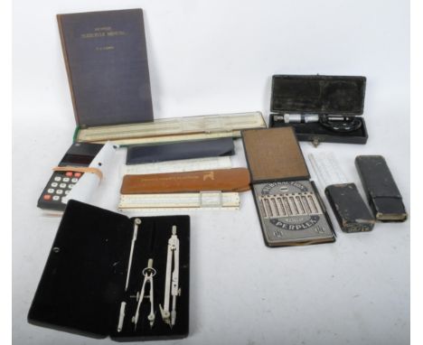 A collection of vintage 20th Century slide rules and related office / mathematical equipment. The lot to include four slide r