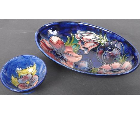 Two vintage mid 20th century Moorcroft blue ground dishes&nbsp;having floral textured decorations. The lot to include an oval
