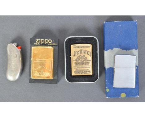 A collection of vintage lighters. Including USA made Zippo, Marlboro, Jim Beam whiskey, and a plain text one. Together with a