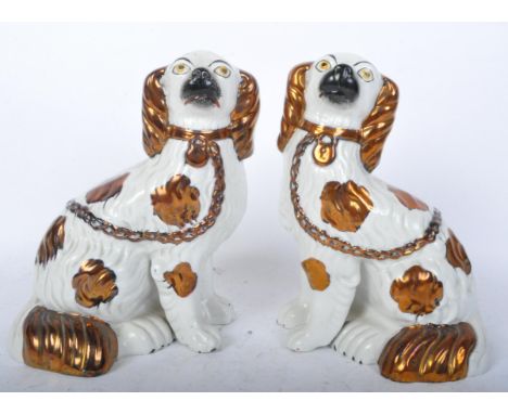 Two vintage 20th century Staffordshire flatback King Charles dogs having handpainted features with gilt detailing. Measures 1