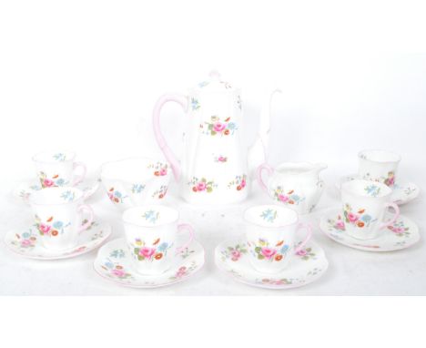 A vintage mid 20th Shelley bone china coffee service in the rose spray pattern. The set decorated with printed chintz rose de