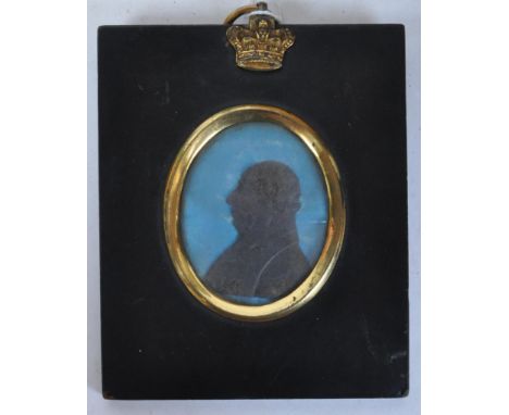 A 19th century miniature memorial ceramic silhouette portrait to depict King George III. The portrait being set again royal b