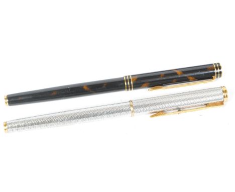 Two vintage 20th century Waterman fountain pens. One having a lucite case with 18ct gold nib, together with a textured white 
